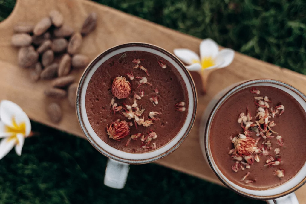 Two ceremonial cacao cups with rose petals — Couples Cacao Ceremony New Orleans